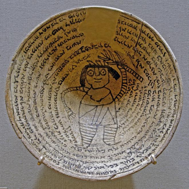 Incantation bowl with an Aramaic inscription around a demon, from Nippur, Mesopotamia, 6–7th century.